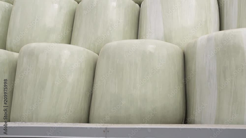 A few large milled grain bags wich placed side by side on modern clean bright factory back yard A few large milled grain bags wich placed side by side on modern clean bright factory back yard
