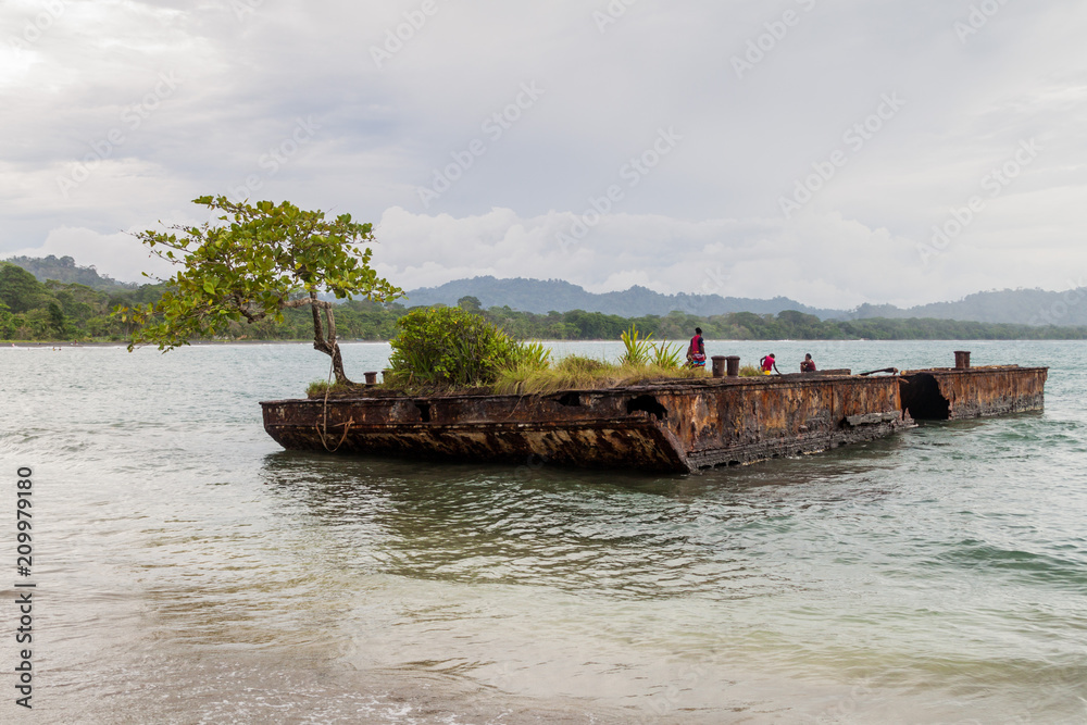 PUERTO VIEJO DE TALAMANCA, COSTA RICA - MAY 16: People on a rusty pontoon in Puerto Viejo de Talamanca village, Costa Rica PUERTO VIEJO DE TALAMANCA, COSTA RICA - MAY 16: People on a rusty pontoon in Puerto Viejo de Talamanca village, Costa Rica