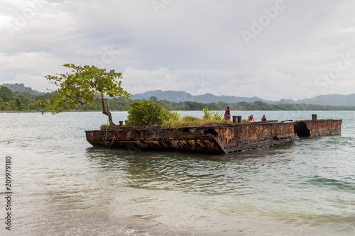 PUERTO VIEJO DE TALAMANCA, COSTA RICA - MAY 16: People on a rusty pontoon in Puerto Viejo de Talamanca village, Costa Rica