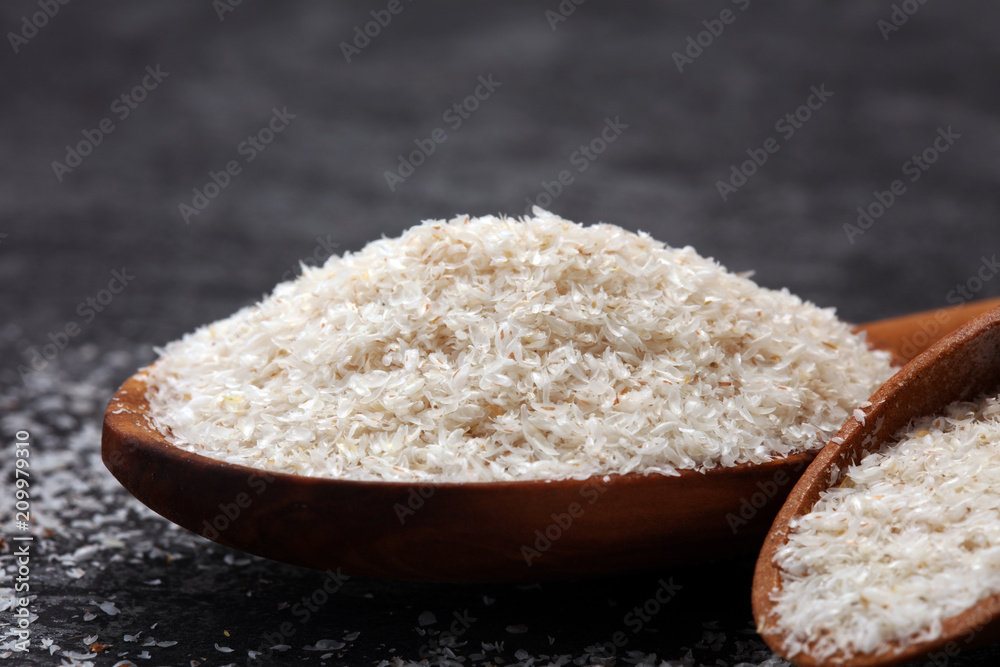 Portion of Psyllium Seeds on rustic dark background. Psyllium seed husks Portion of Psyllium Seeds on rustic dark background. Psyllium seed husks