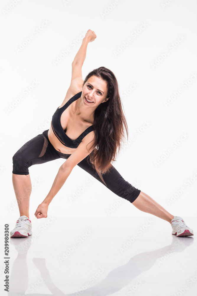 Sporting girl is engaged in fitness on a white background Sporting girl is engaged in fitness on a white background