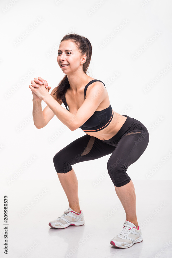 Sporting girl is engaged in fitness on a white background Sporting girl is engaged in fitness on a white background