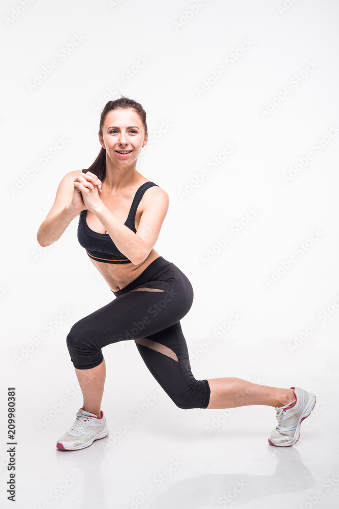  Sporting girl is engaged in fitness on a white background