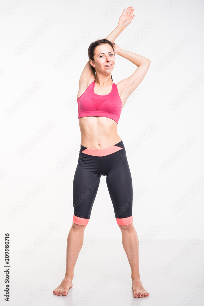 Sporting girl is engaged in fitness on a white background Sporting girl is engaged in fitness on a white background