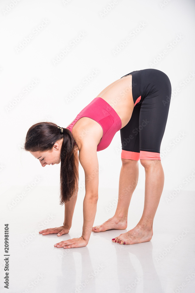 Sporting girl is engaged in fitness on a white background Sporting girl is engaged in fitness on a white background