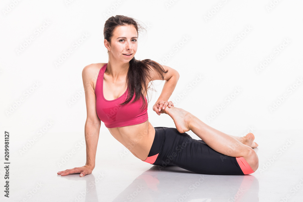 Sporting girl is engaged in fitness on a white background Sporting girl is engaged in fitness on a white background