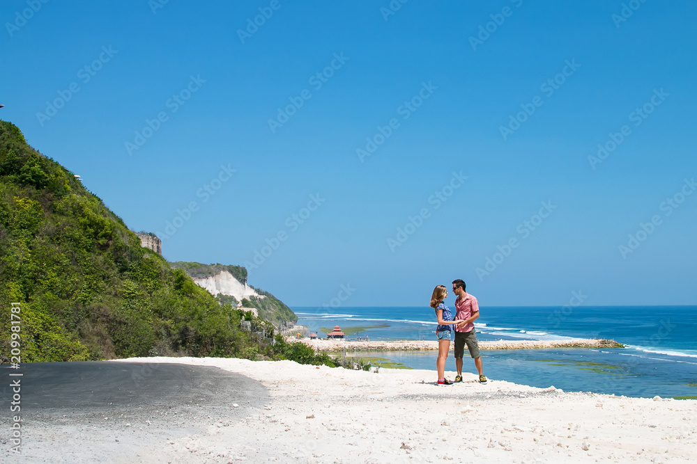 couple stay on cliff exploring new country in honeymoon ocean background couple stay on cliff exploring new country in honeymoon ocean background