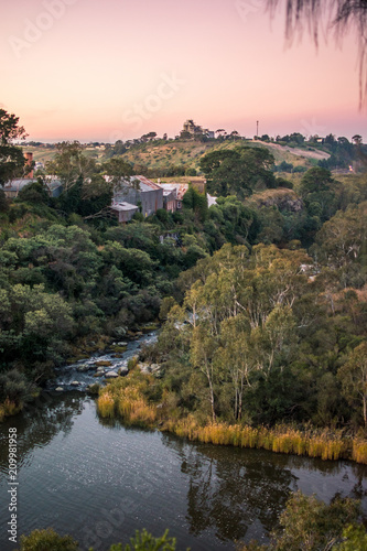 View looking over a lake and river winding between hills during sunset