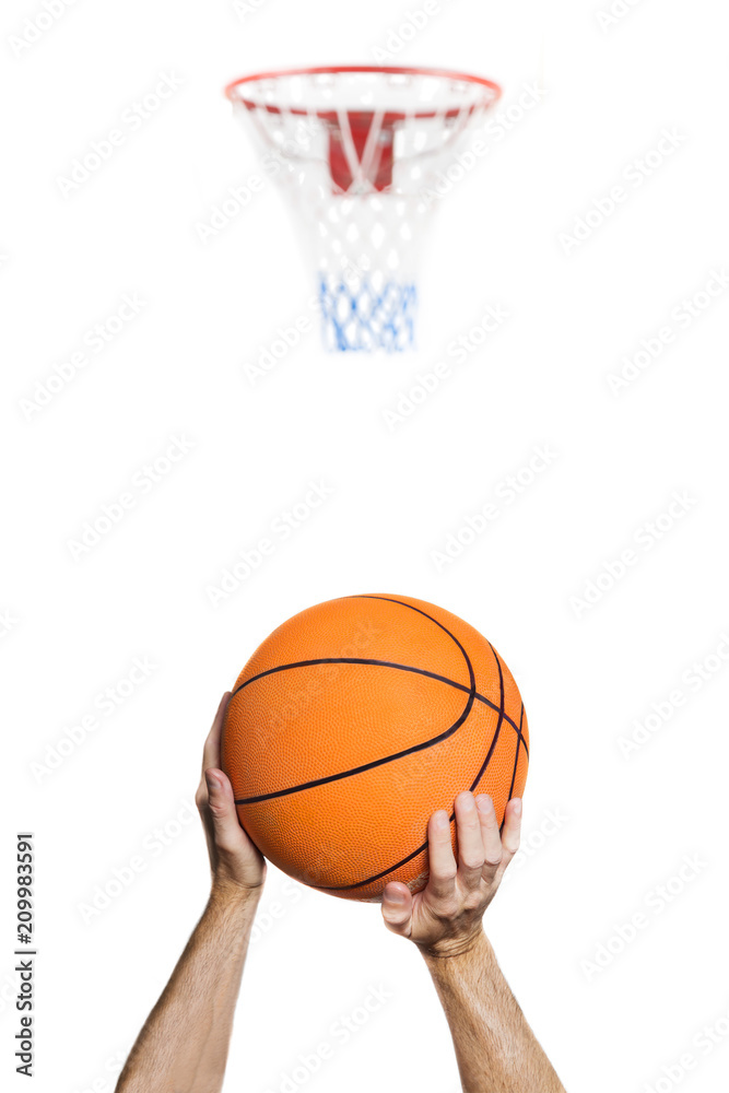 Fototapeta premium .isolated on white shooting at the basket / portrait of the arms of a basketball player intent on shooting the basket