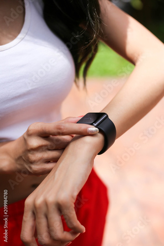 Health sport young woman look wear smart watch device checking performance, Sport and fitness concept.
