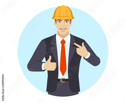 Businessman in construction helmet  showing thumb up and  pointing the finger at himself