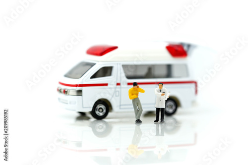 Miniature people : Doctor and Paramedic attending to patient in ambulance,Medicine ambulance concept