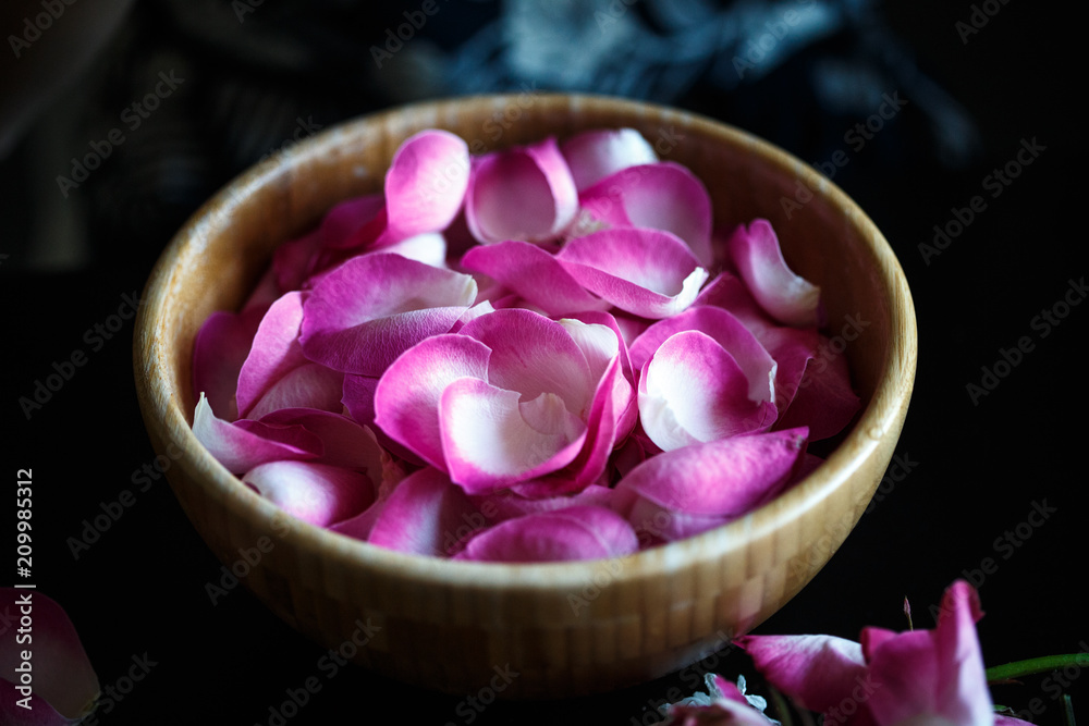 Close-up macro photo of rose petals in a wooden bowl Close-up macro photo of rose petals in a wooden bowl