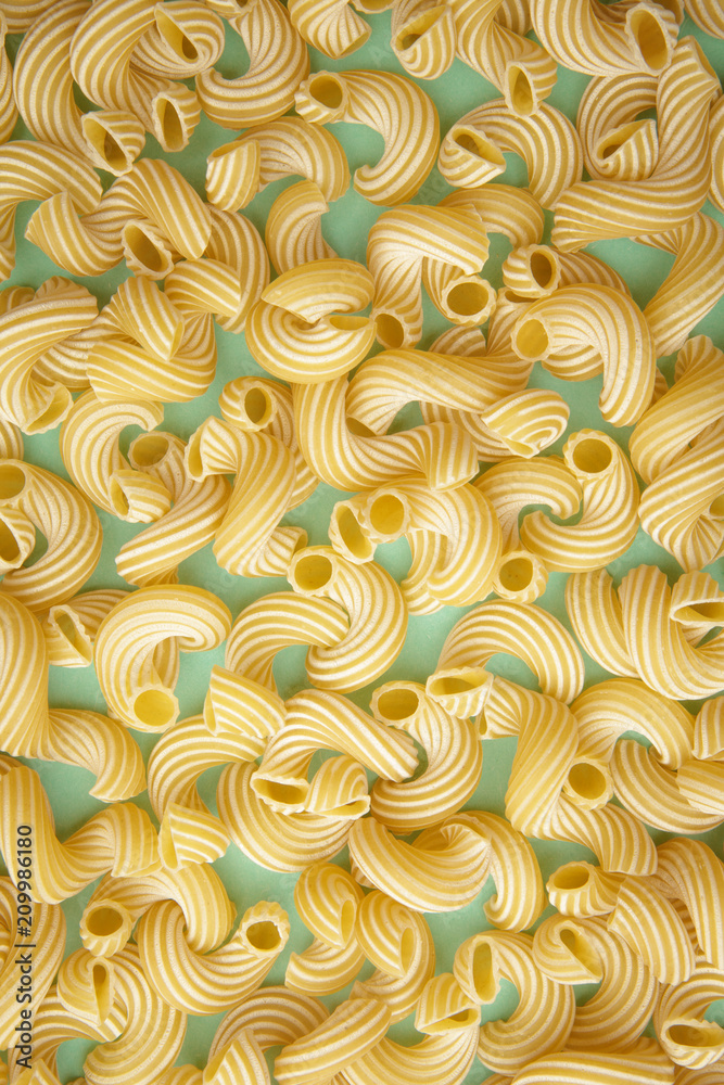 background of pasta in the form of tubes spun in a spiral background of pasta in the form of tubes spun in a spiral