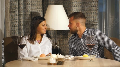 a beautiful bearded man gives a gift to his girlfriend in a restaurant photo
