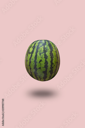 Watermelon isolated on a pink pastel background with a shadow