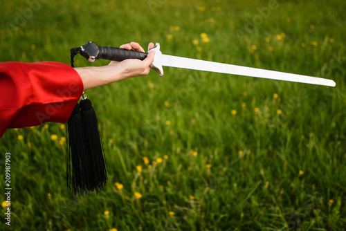 Man in ethnic samurai japanese clothing uniform with katana sword