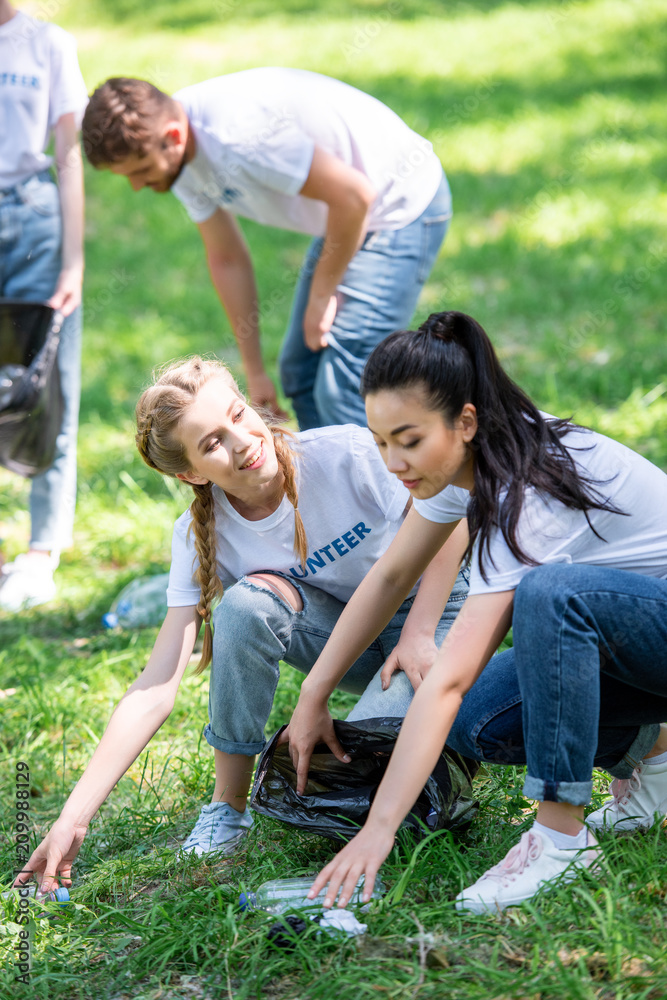 young happy volunteers cleaning green lawn young happy volunteers cleaning green lawn