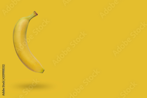 Banana isolated on yellow background with a shadow