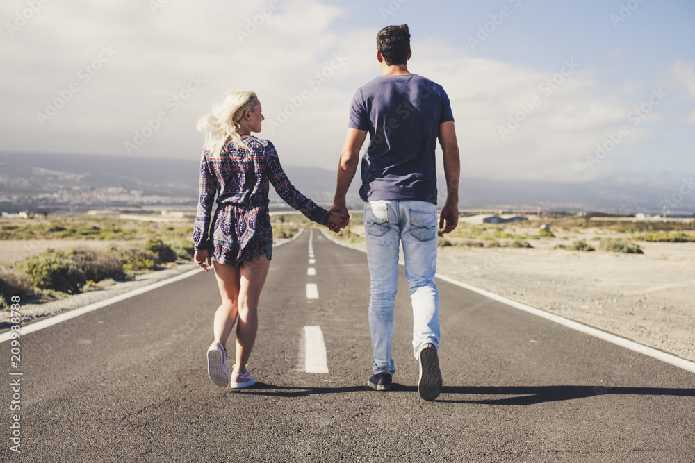 couple of lover in friendship and relationship walk together forever on a long infinite road. travel and life in family concept. team winner and outdoor lifestyle couple of lover in friendship and relationship walk together forever on a long infinite road. travel and life in family concept. team winner and outdoor lifestyle