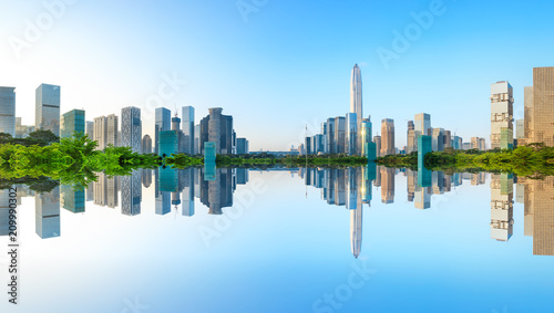Beautiful modern city skyline and water reflection in Shenzhen at sunrise