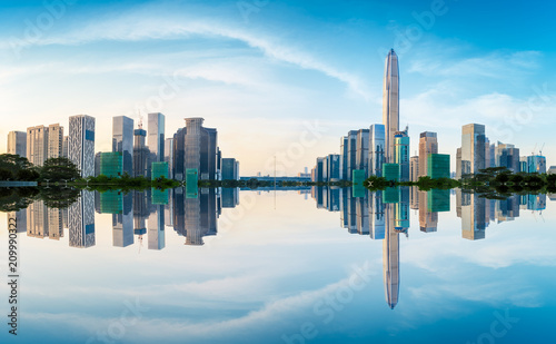 Beautiful modern city skyline and water reflection in Shenzhen at sunrise