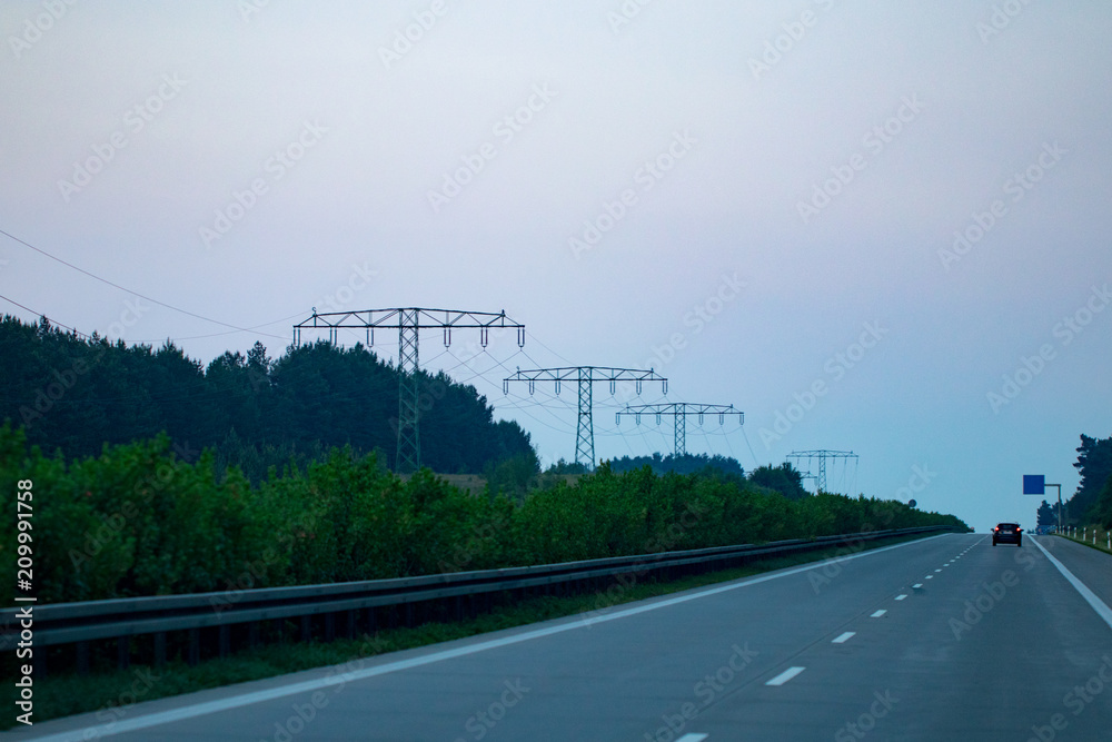 Highway traffic in sunset with cars and trucks Highway traffic in sunset with cars and trucks