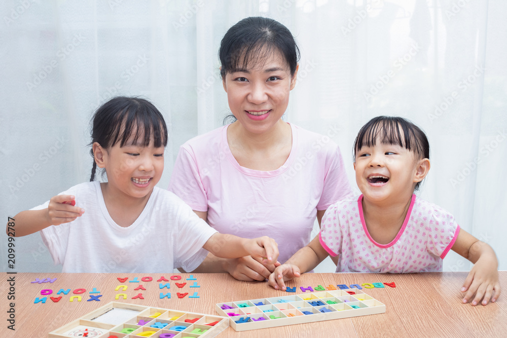 Asian Chinese Family Playing with colorful wooden alphabet toys