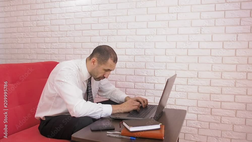 Tired man at the computer. Businessman falls asleep behind a laptop. Tired man at the computer. Businessman falls asleep behind a laptop.