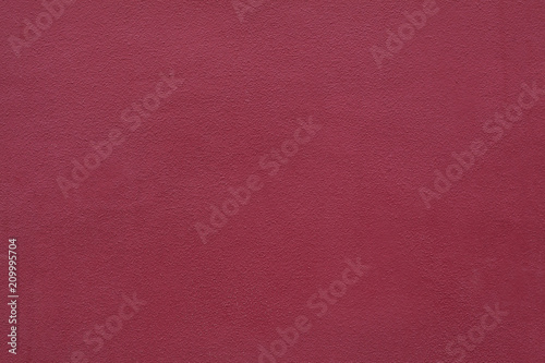 Burgundy red painted stucco wall. Background texture