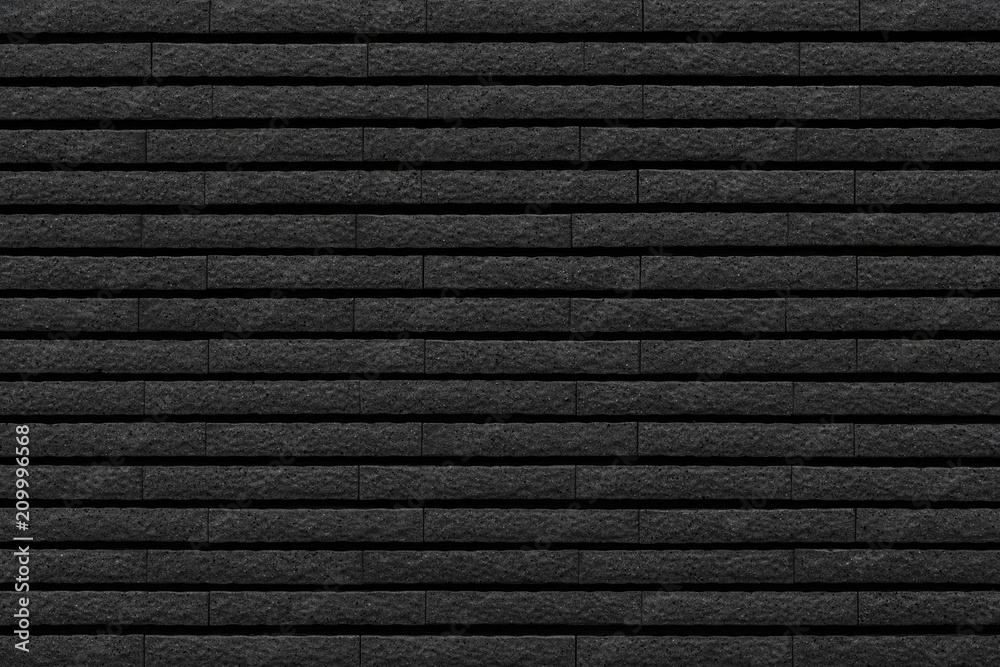 Black stone brick tile wall pattern and background Black stone brick tile wall pattern and background
