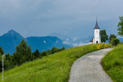 Church of St. Primus and Felician, Jamnik Slovenia at stormy weather