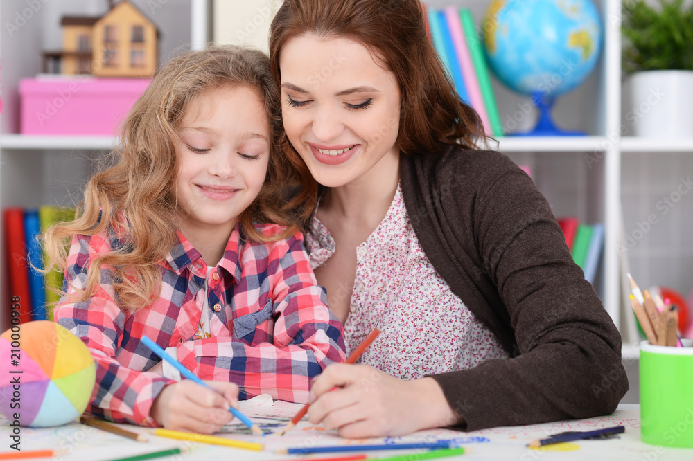 little girl with her mother drawing little girl with her mother drawing