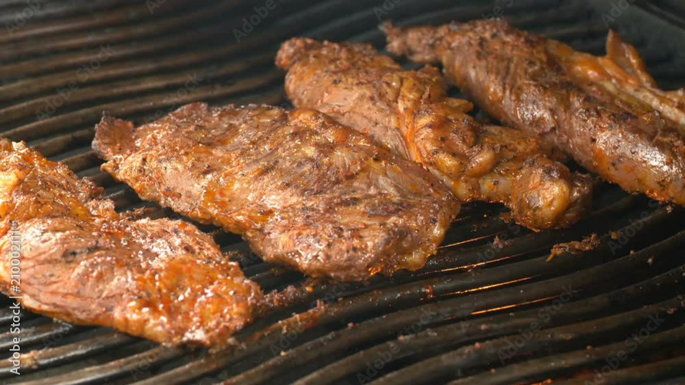 UHD shot of the delicious seasoned beef on the grill UHD shot of the delicious seasoned beef on the grill