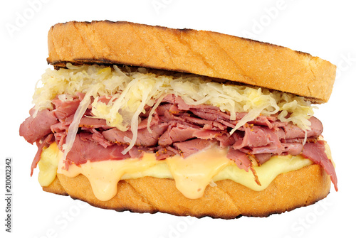 Pastrami Reuben style sandwich with sauerkraut and Swiss cheese isolated on a white background