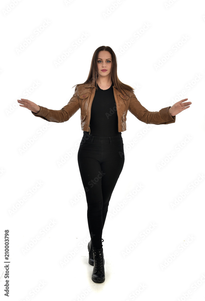 full length portrait of brunette girl wearing brown leather jacket. standing pose on white background. full length portrait of brunette girl wearing brown leather jacket. standing pose on white background.