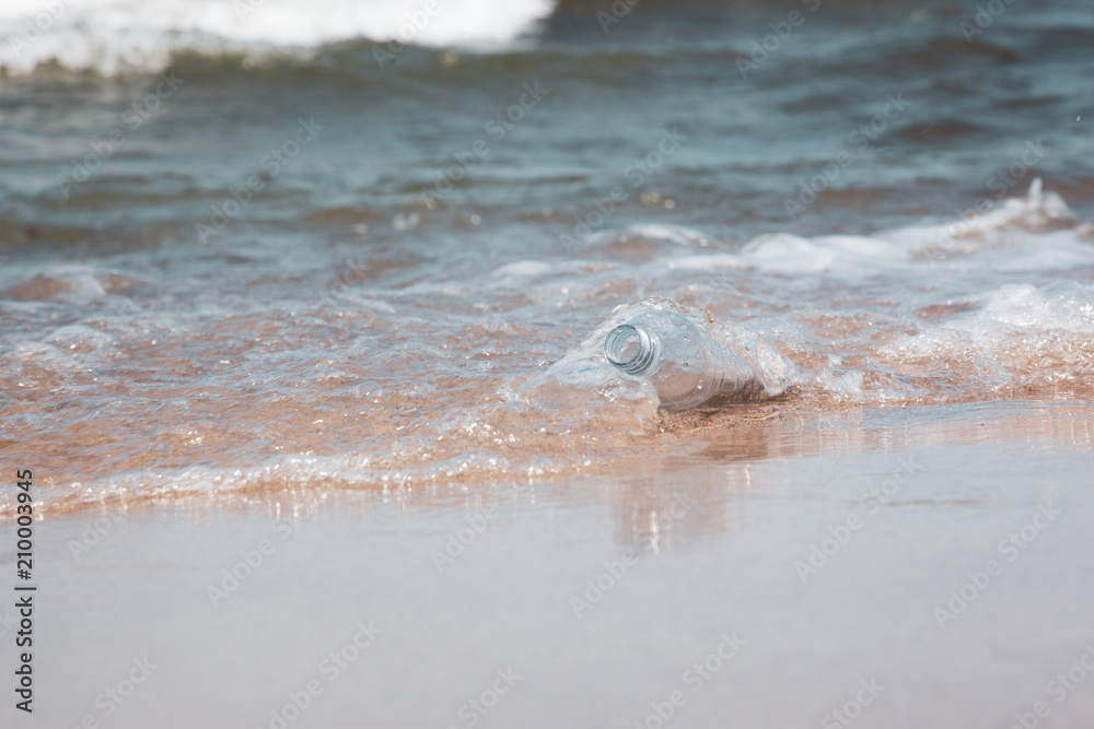 Fototapeta premium Plastic bottle in ocean water, littering the sea concept image