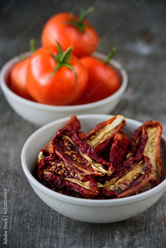 Bowls of fresh and dried tomatoes