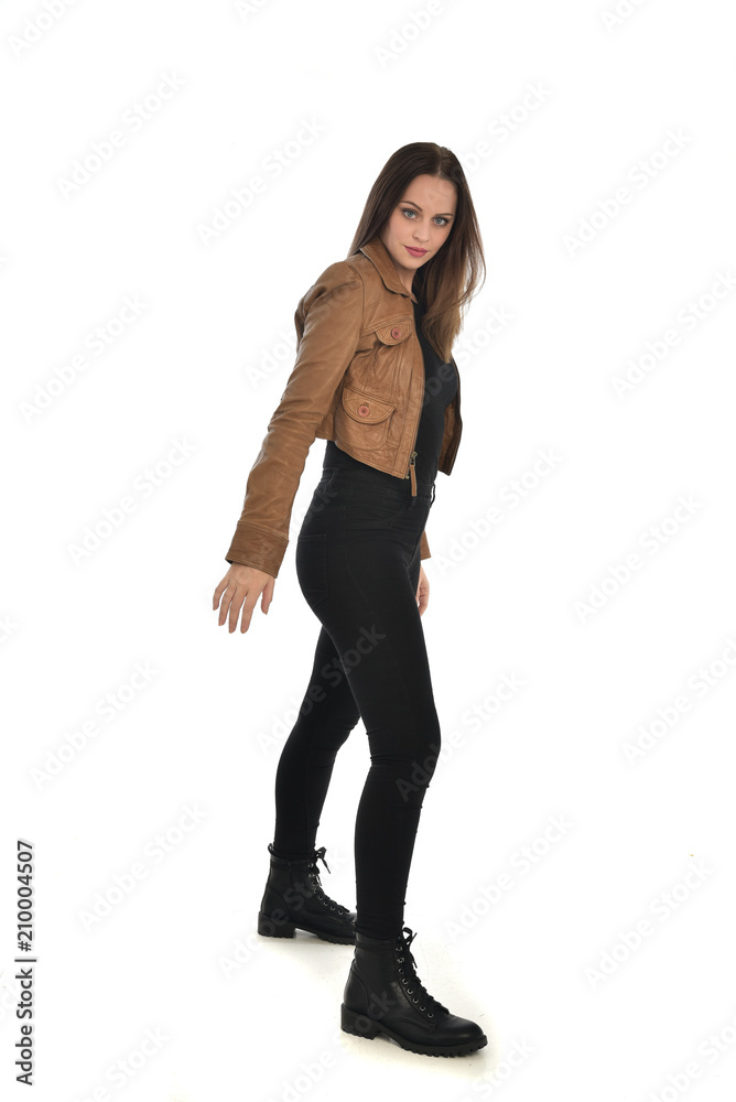 full length portrait of brunette girl wearing brown leather jacket. standing pose on white background. full length portrait of brunette girl wearing brown leather jacket. standing pose on white background.