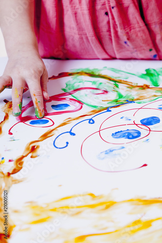 little girl learning to paint (child development in art)