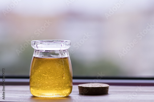 Honey in glass jar closeup,