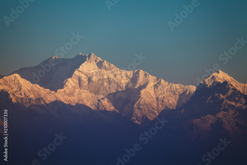 Mount Kanchenjunga peak with snow in beams of the  sunrise - the mountain  the third on height  in the world  on border of Nepal and the Indian state of Sikkim.
