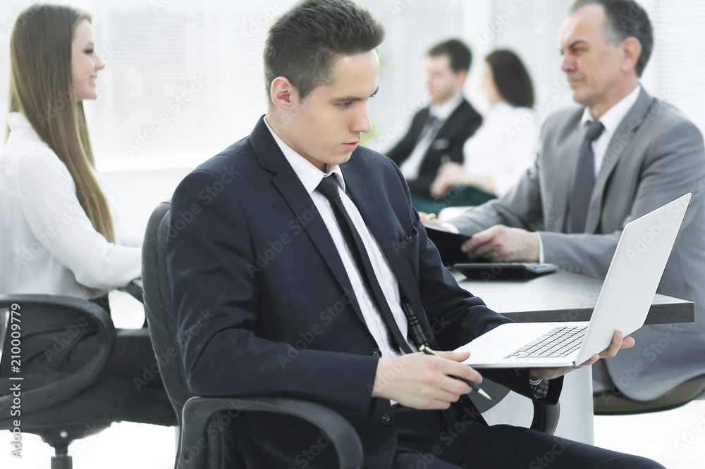 close up.young businessman looking at the laptop screen close up.young businessman looking at the laptop screen