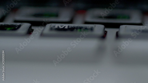 Close-up view fingers tapping keypad of laptop and writing message