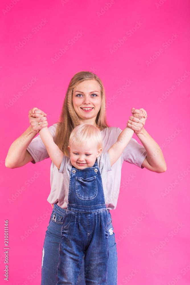mother and daughter having fun isolated on pink background mother and daughter having fun isolated on pink background