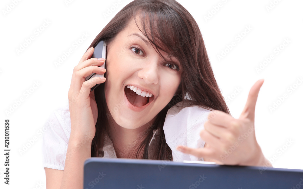 smiling young woman sitting behind a Desk and showing thumb up. smiling young woman sitting behind a Desk and showing thumb up.