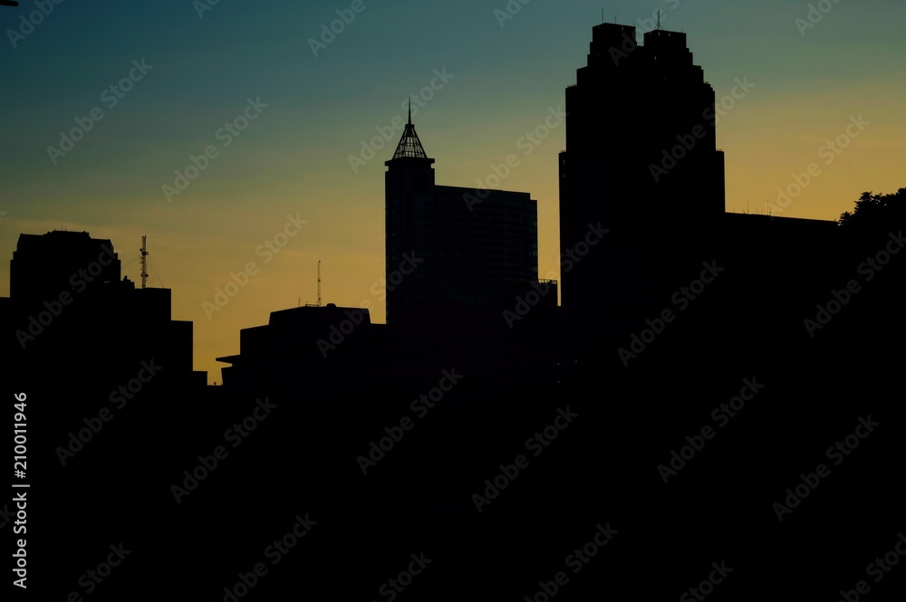 Silhouettes of the towers along the skyline of downtown Raleigh North Carolina just before sunrise on a clear morning