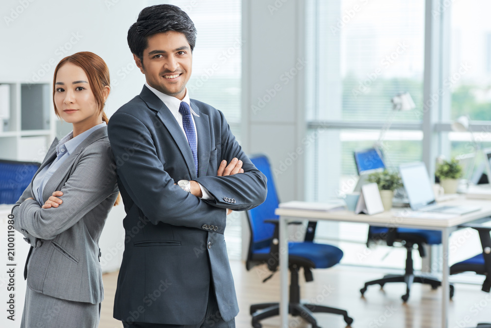 Portrait of young business team standing at office with arms crossed Portrait of young business team standing at office with arms crossed