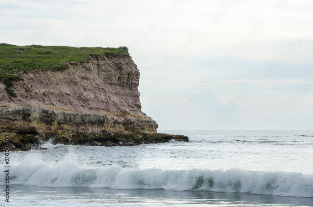 Coastal landscape in Northern Angola with rocky cliff, small waves and white light, N'zeto, Africa