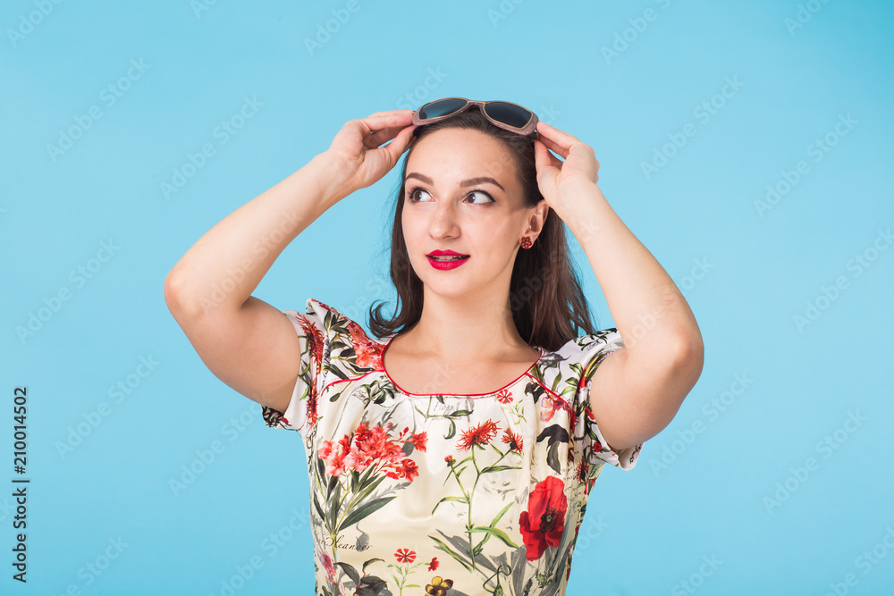Confident girl smiling to camera. Portrait of woman over blue background Confident girl smiling to camera. Portrait of woman over blue background